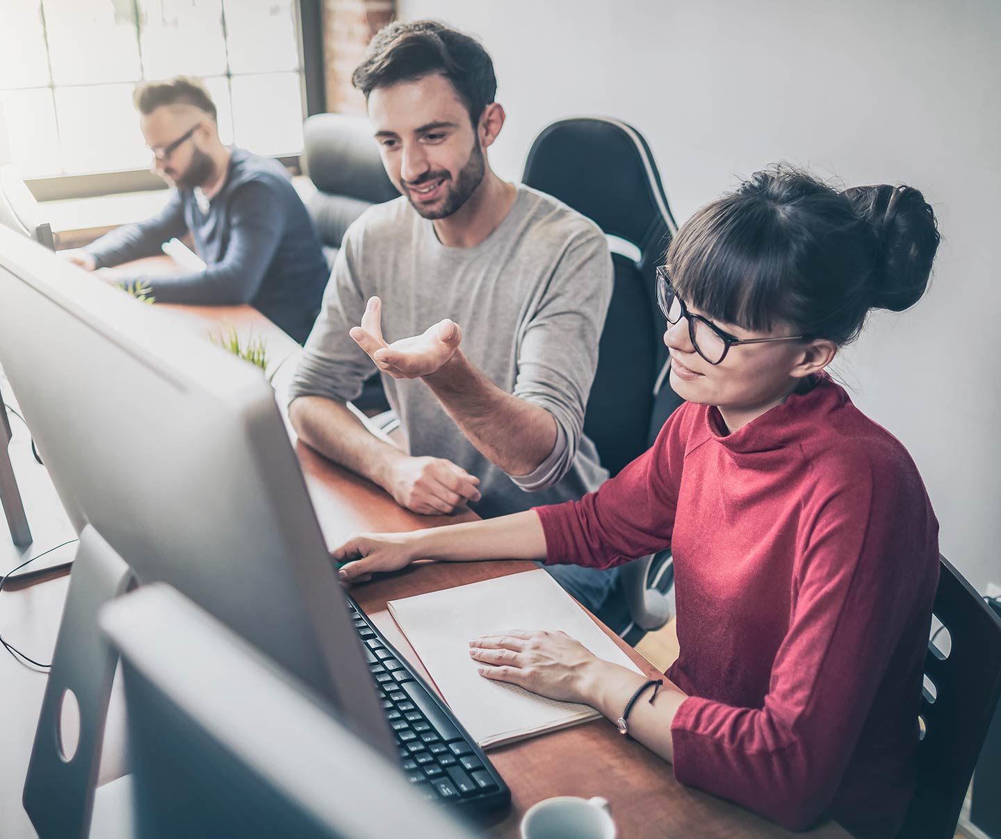 Office workers creating a site on Adobe DXP