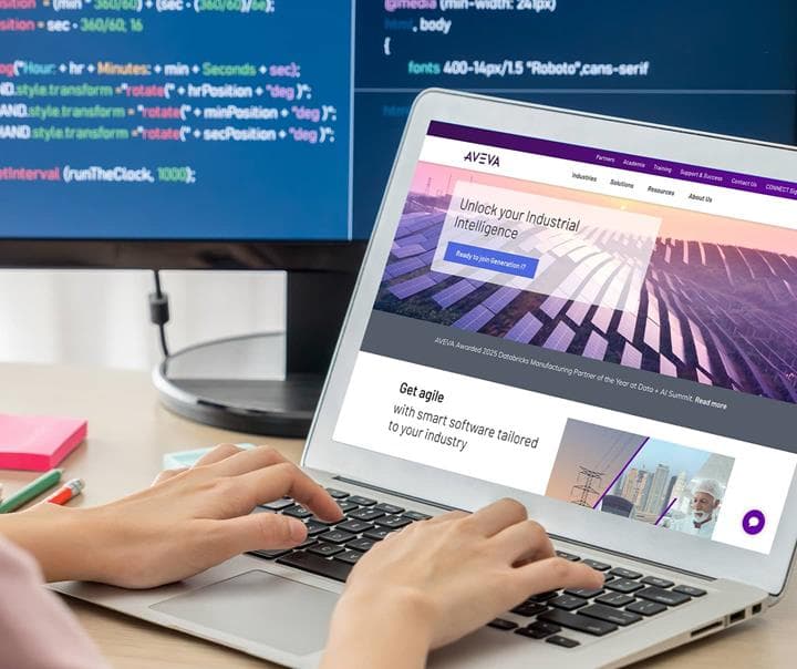 Developer with AVEVA homepage in their laptop screen