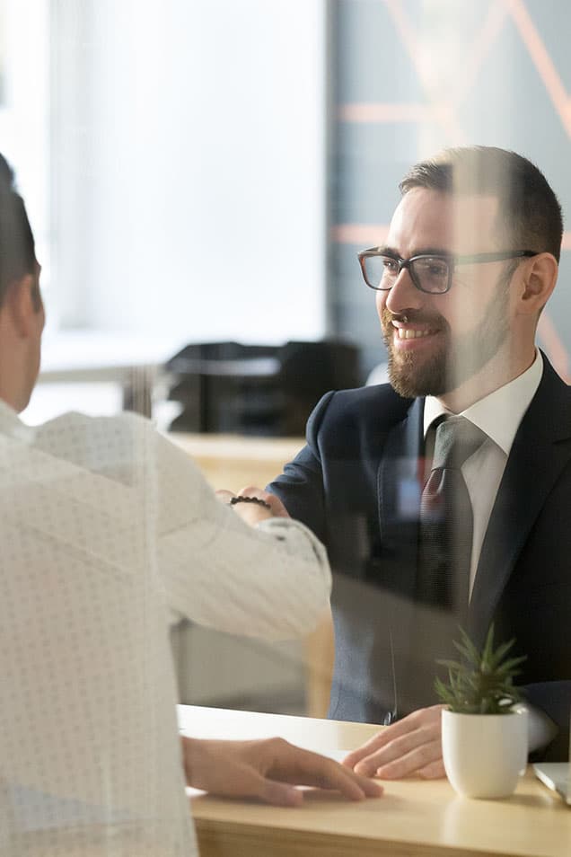 Financial Services employee shaking hands with customers