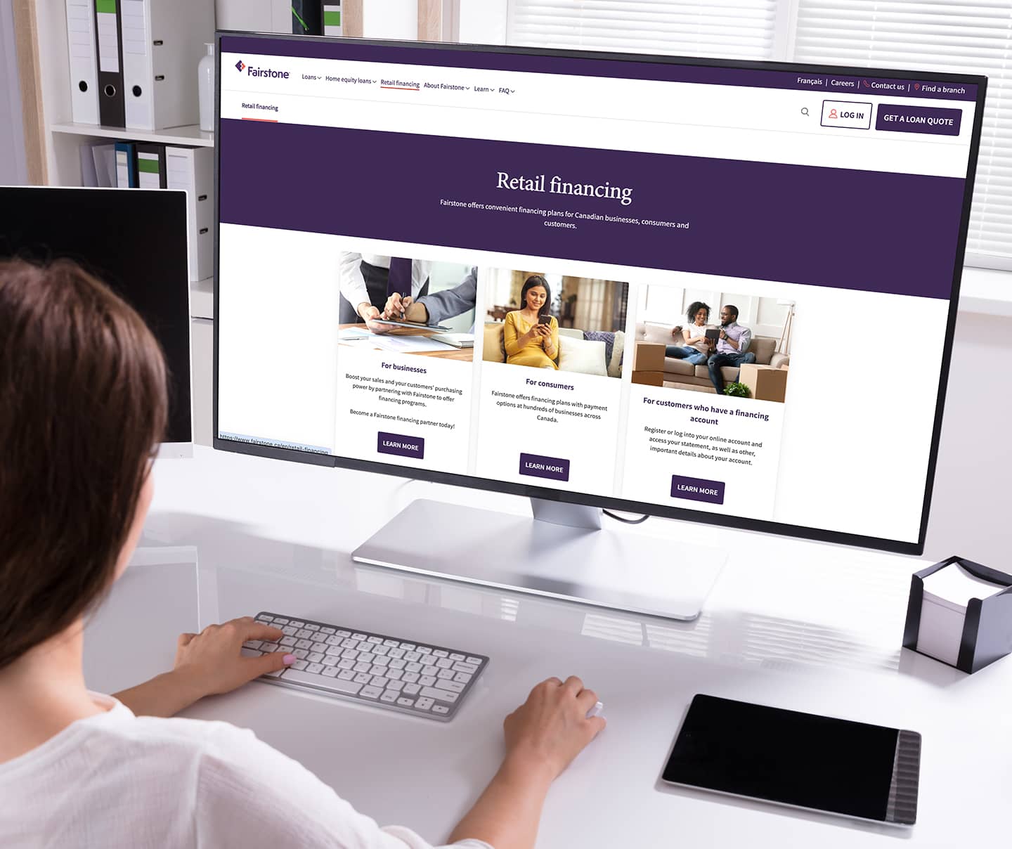 Woman on a computer looking at Fairstone Financial website