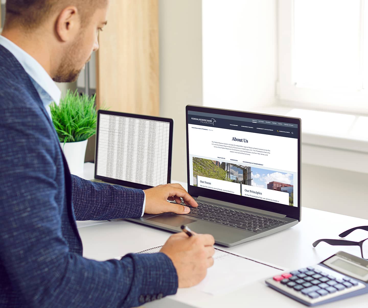Man looking at the About Page of the Federal Reserve Bank of Philadelphia website