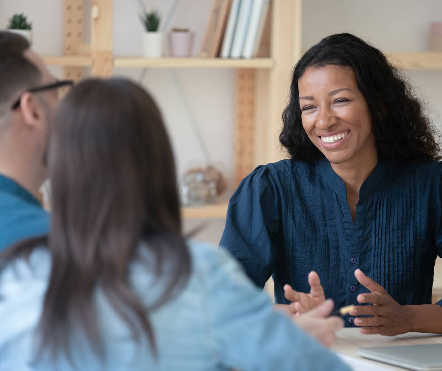 Financial advisor showing presentation on laptop to a couple