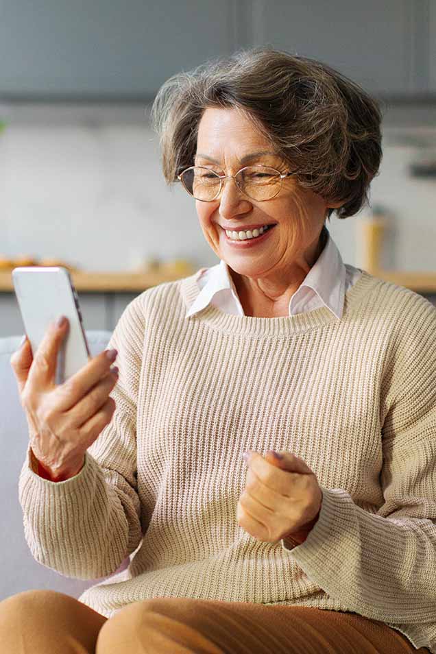 Elderly woman using TCDRS app on a smartphone