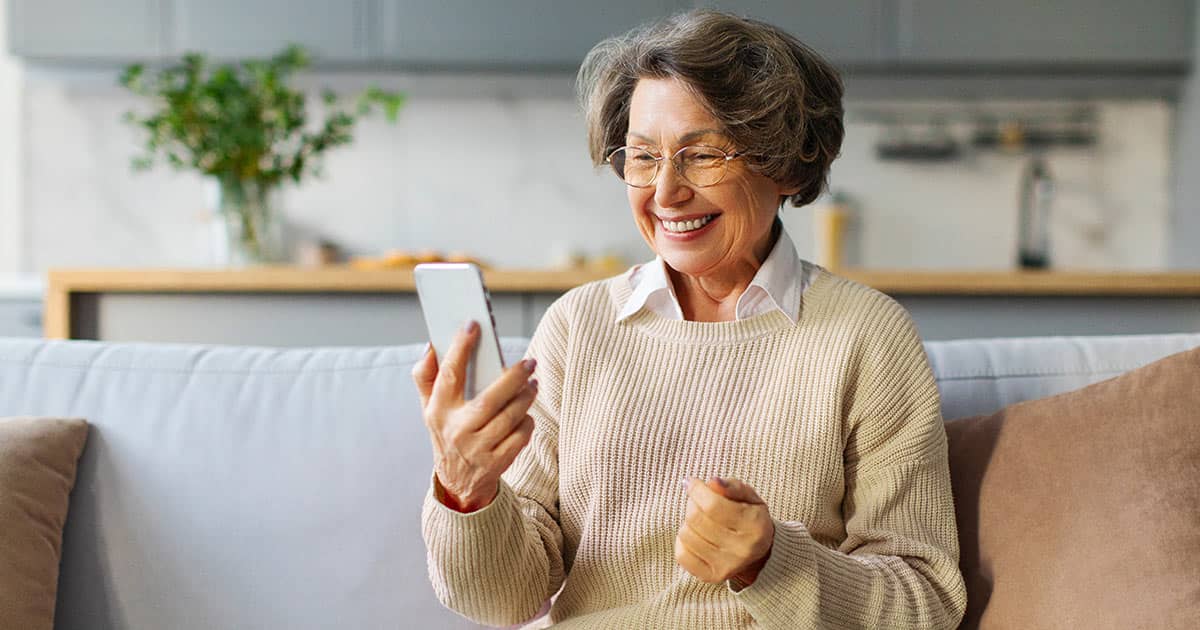 Elderly woman using TCDRS app on a smartphone