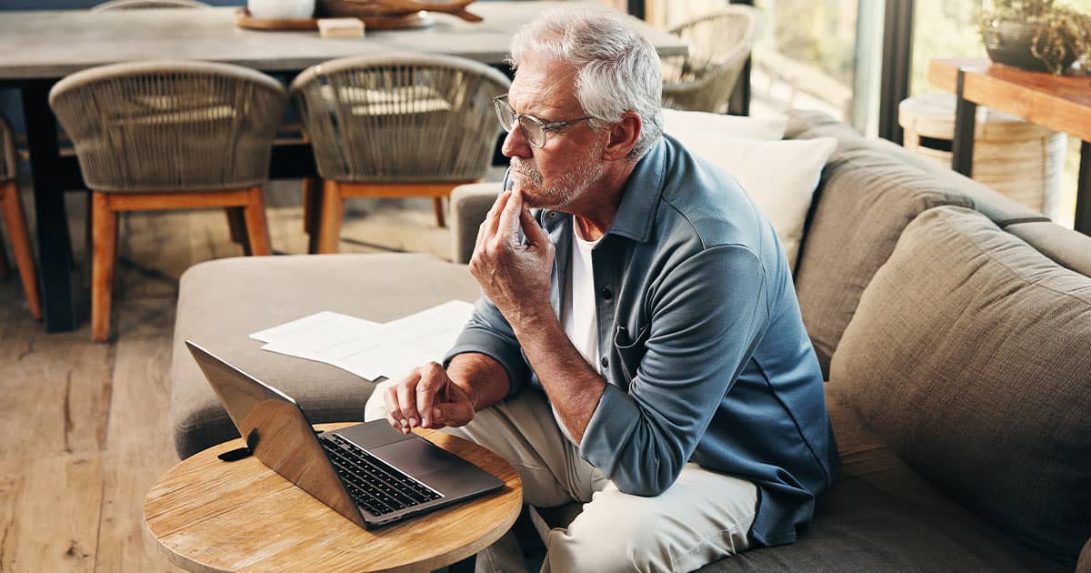 Old man in home with laptop looking at TCDRS website.