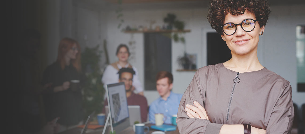 business leader standing in front of team