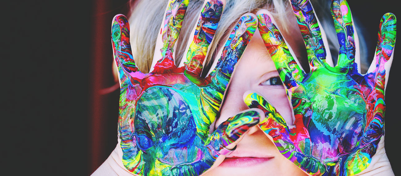 girl with paint swirls on palms