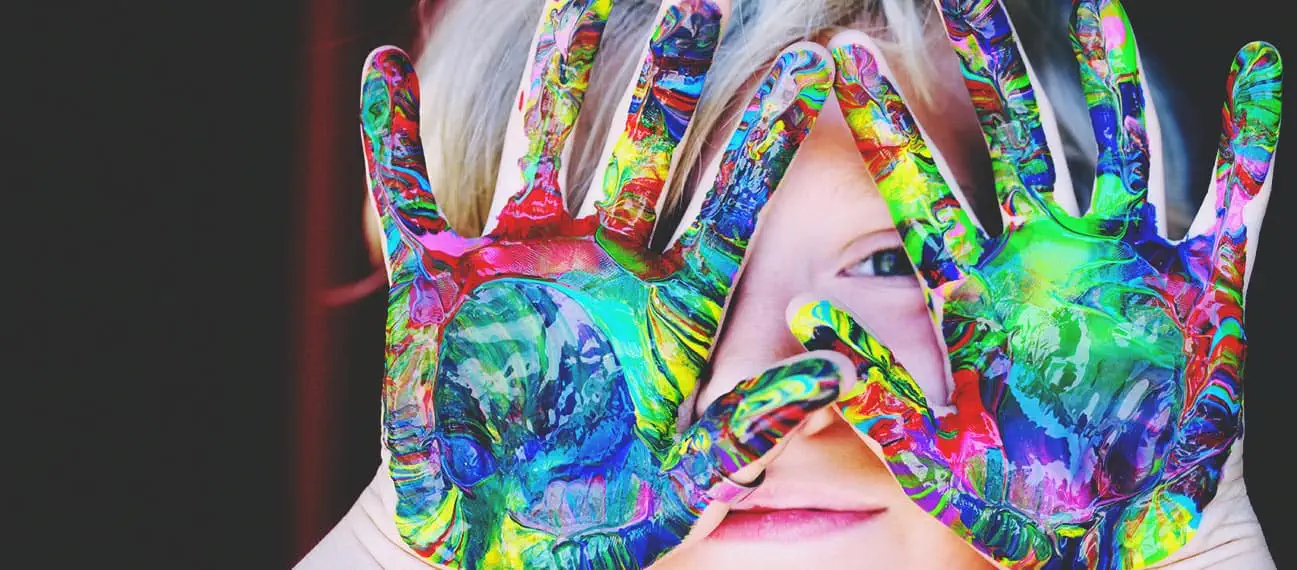 girl with paint swirls on palms