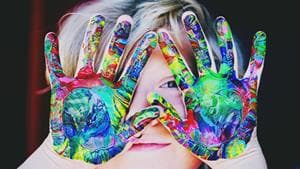 girl with paint swirls on palms