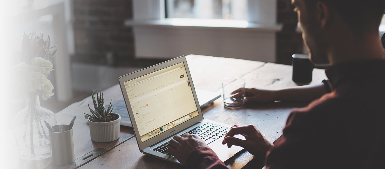 man typing on laptop