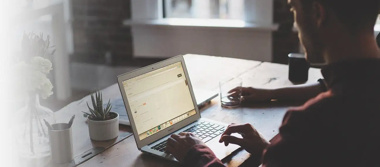 man typing on laptop