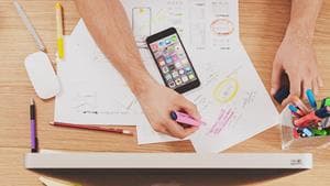marketer planning and writing on papers