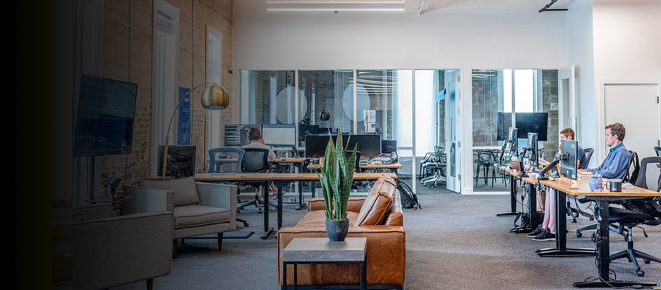 Modern open office with workers using computers