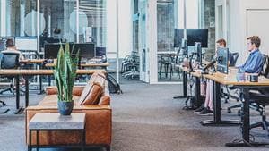 Modern open office with workers using computers
