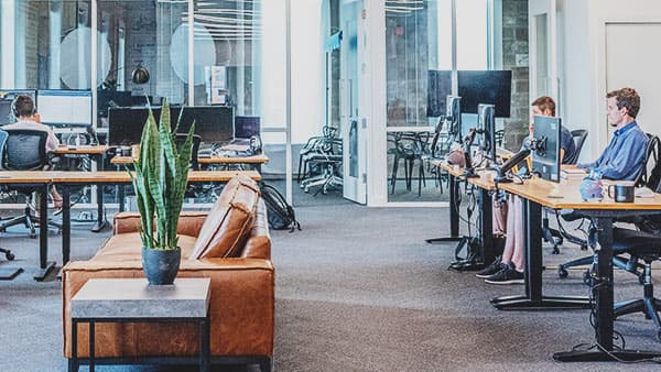 Modern open office with workers using computers