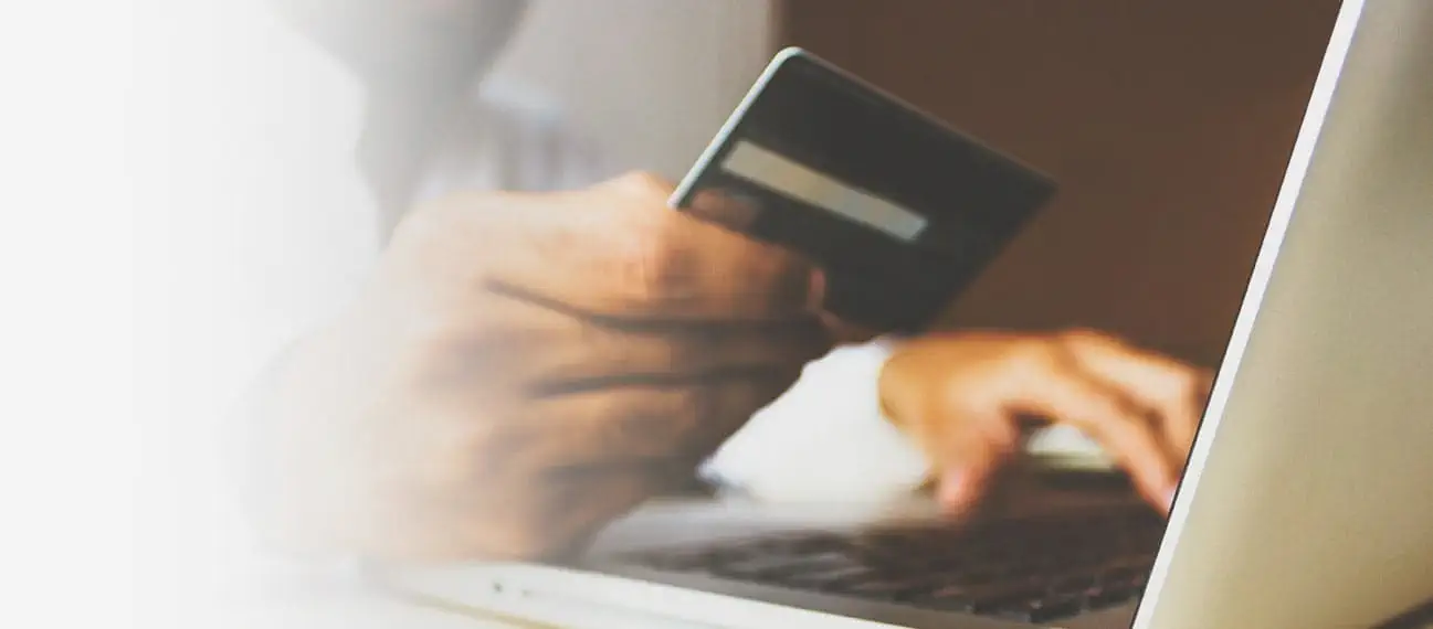 person entering credit card info on laptop