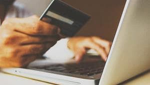 person entering credit card info on laptop