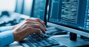 Programmer Typing Code on Computer Keyboard