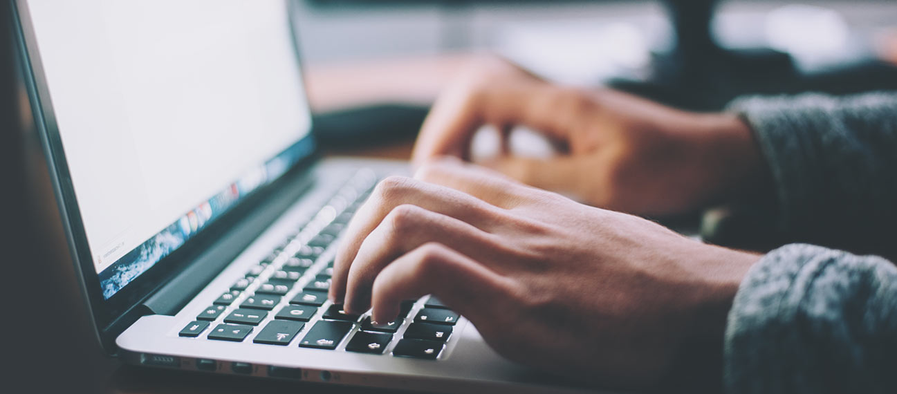 Man interacting with web page on laptop