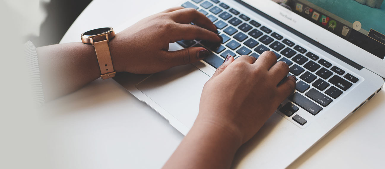 hands typing on laptop