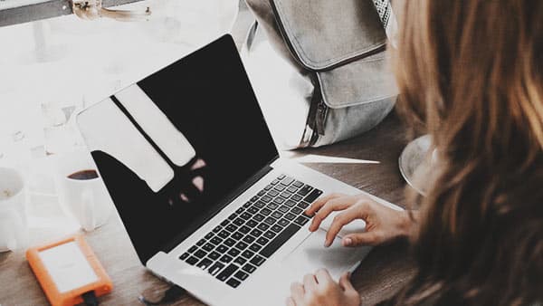 woman typing on laptop