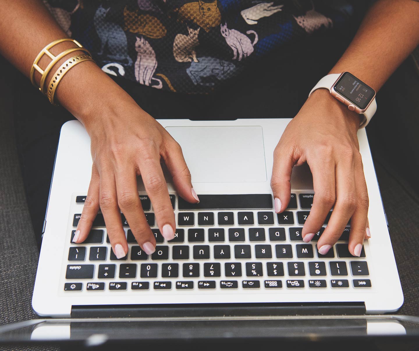 woman typing on a laptop setting up personalization