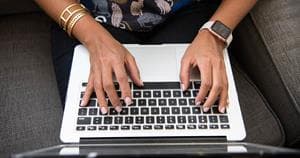woman typing on a laptop setting up personalization