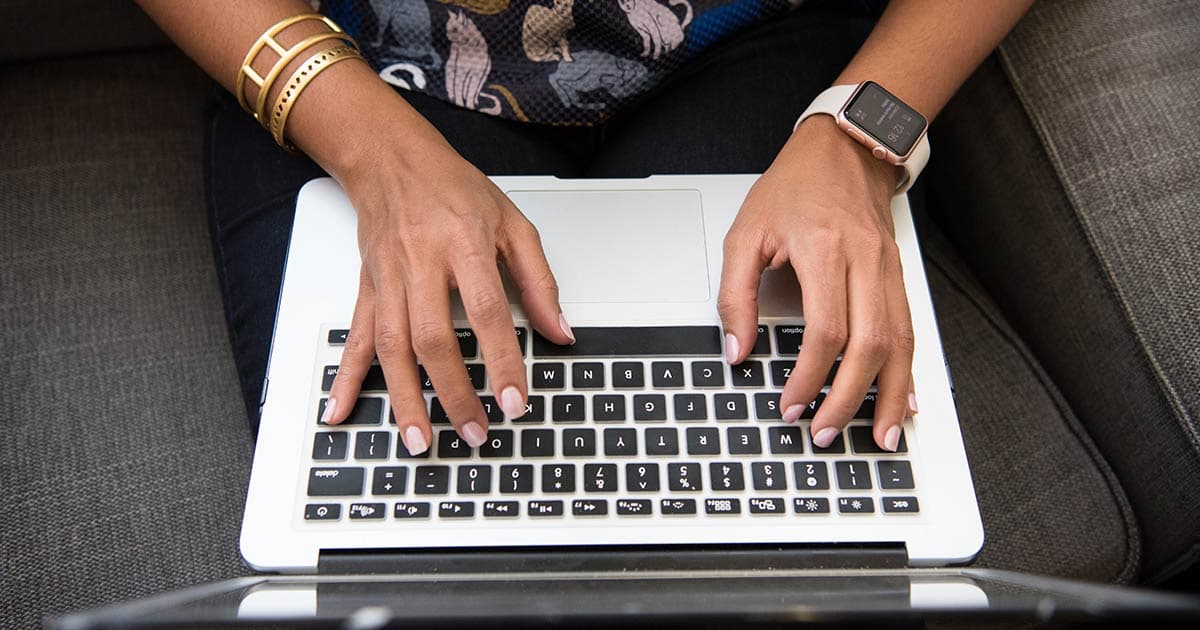 woman typing on a laptop setting up personalization