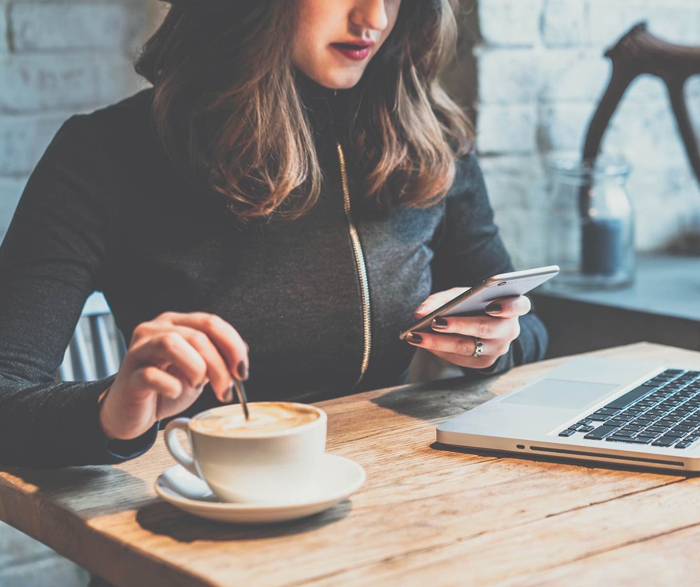 Woman in coffee shop reading email