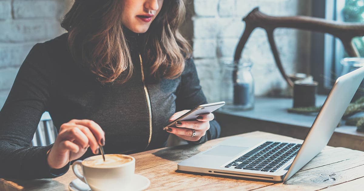 Woman in coffee shop reading email