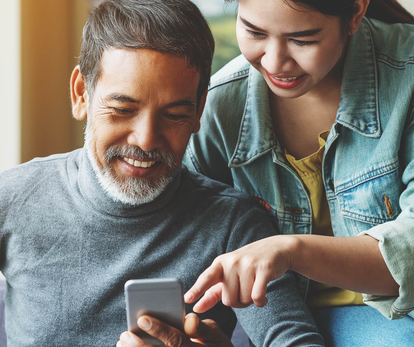 Man and woman viewing a digital experience on mobile