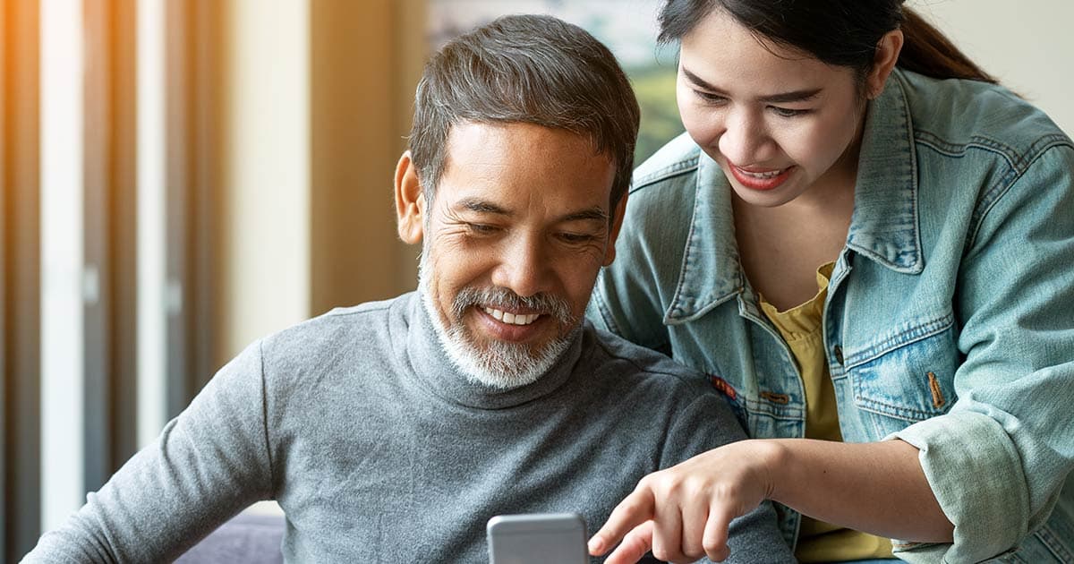 Man and woman viewing a digital experience on mobile