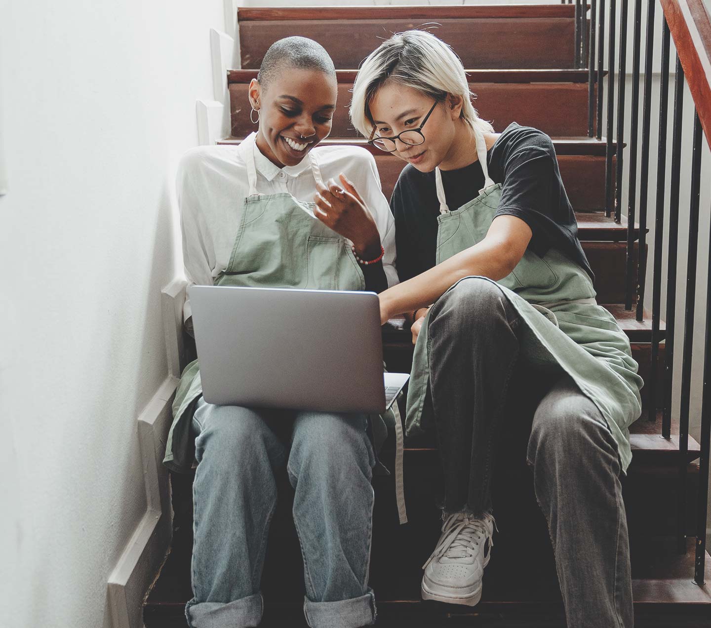 Two people collaborating on a laptop