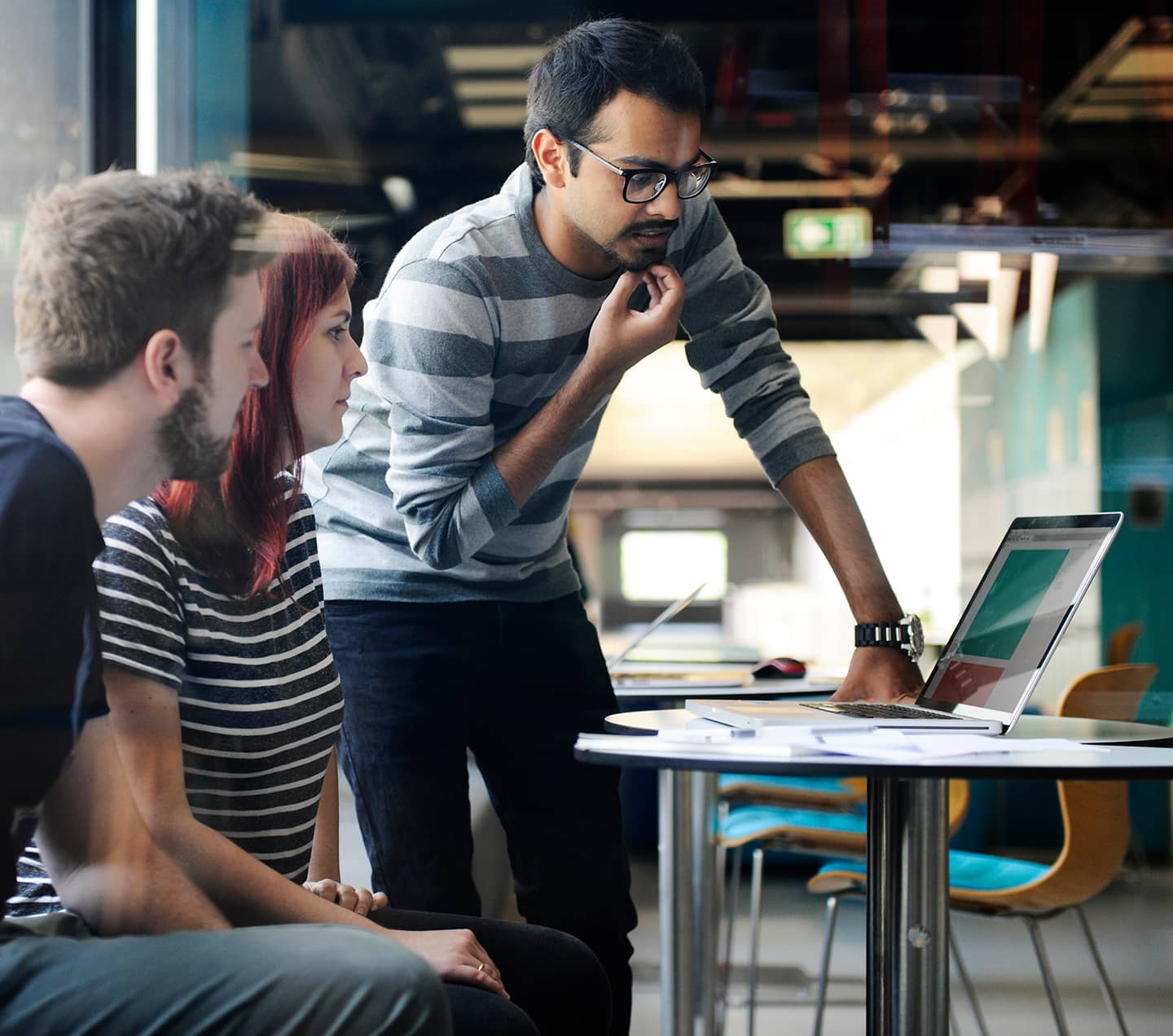 Business people looking at a laptop