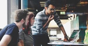 Business people looking at a laptop