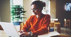 Professional content editor typing in a wireless laptop