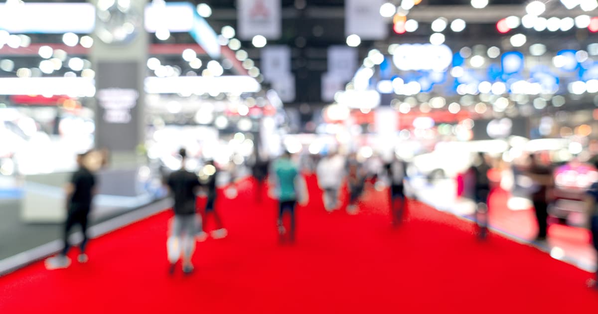 Blurry trade show image with Adobe Summit 2024 logo