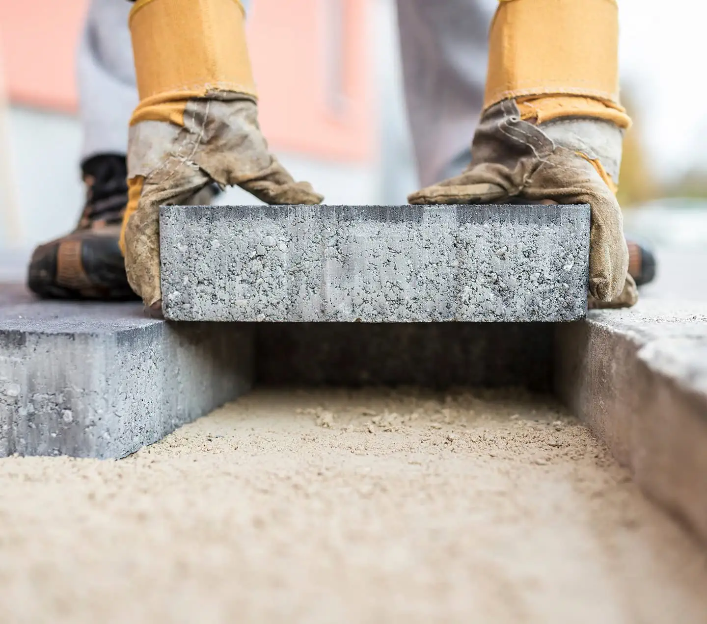 Builder laying outdoor paving slabs