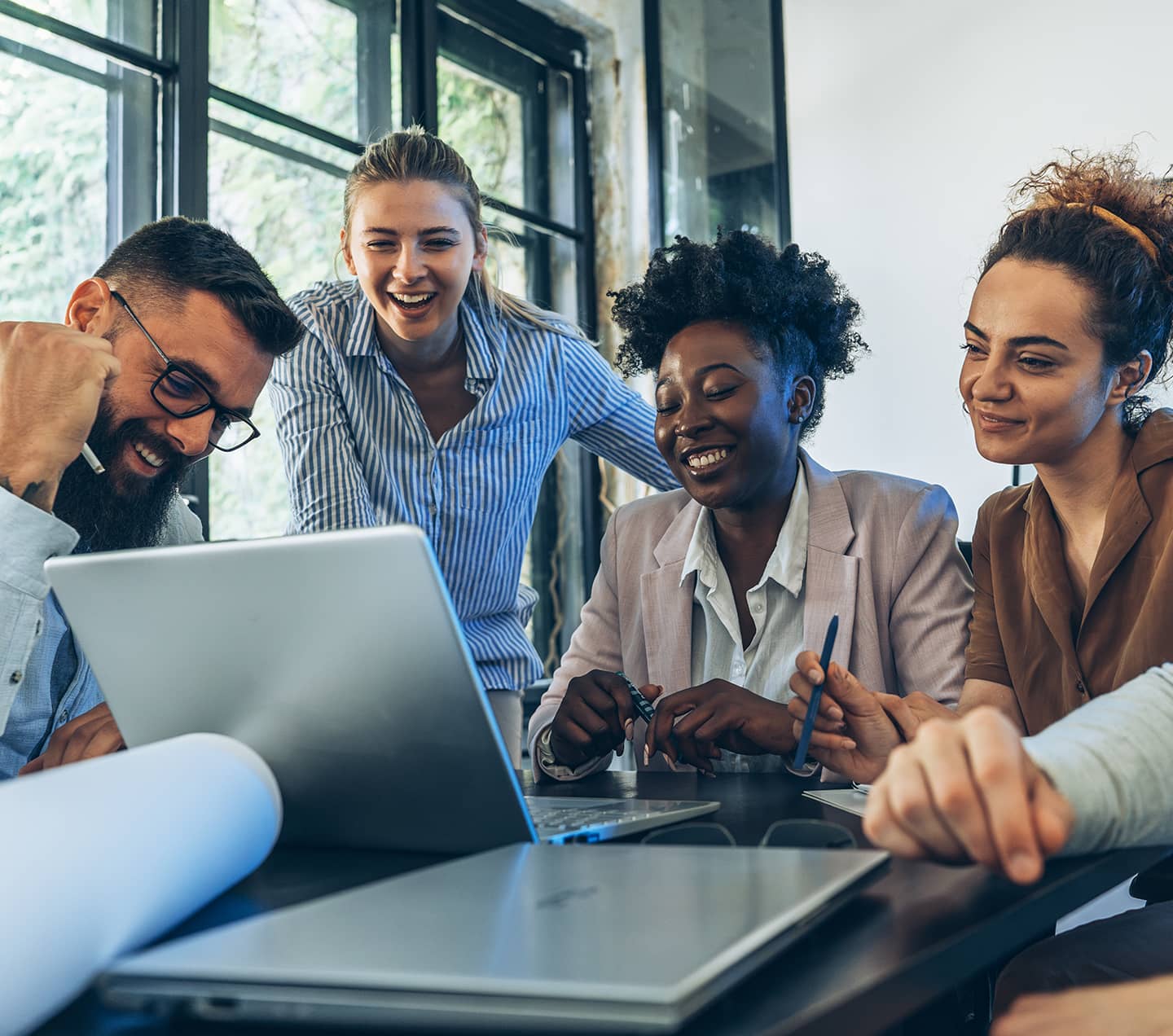 Diverse team looking at a laptop screen