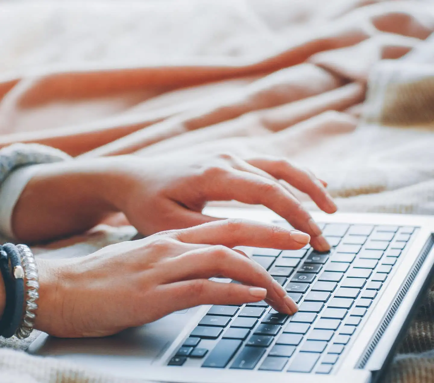 Content author's hands working in a laptop