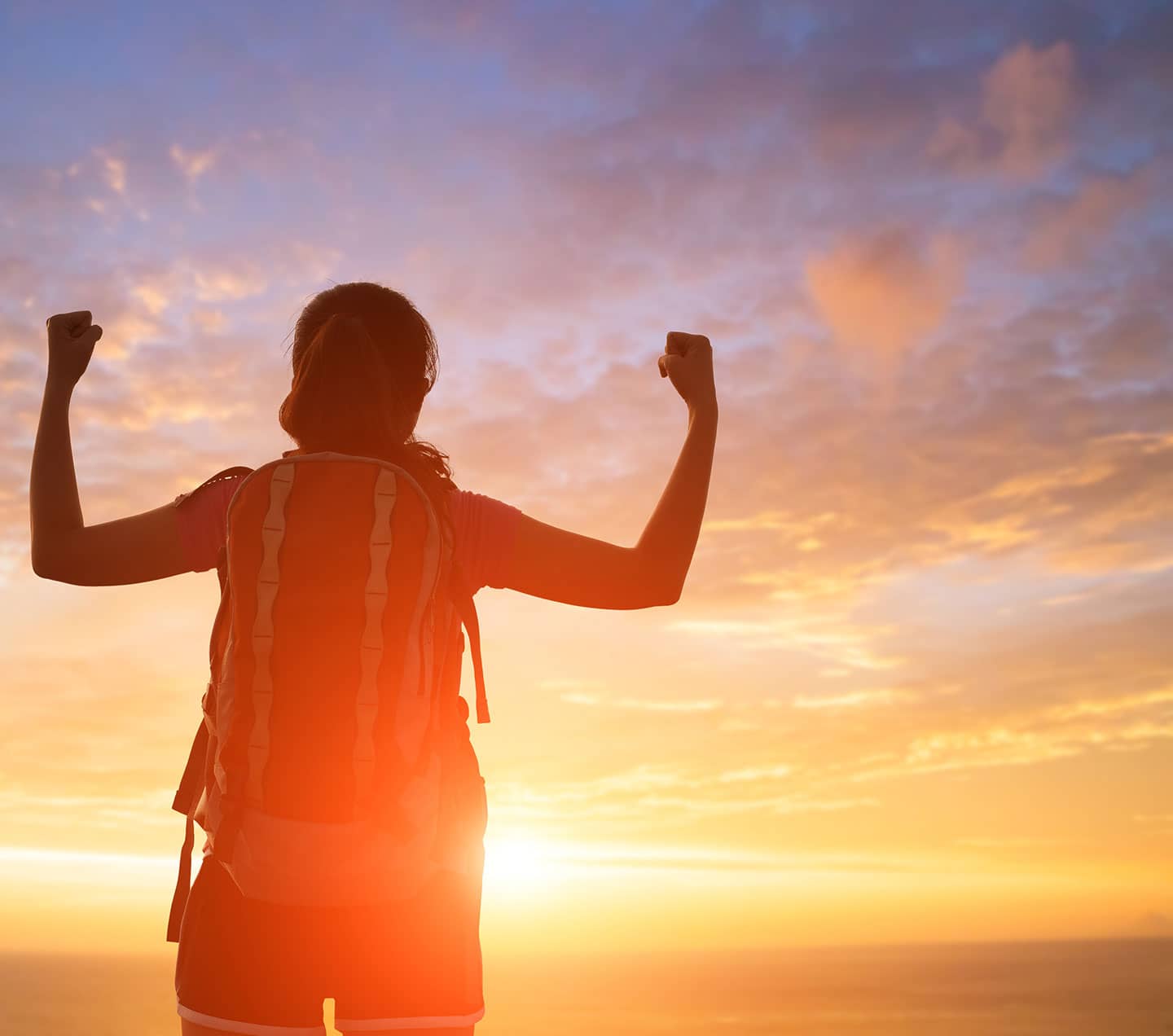 Woman feeling successful in the peak of a mountain