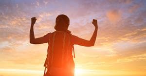 Woman feeling successful in the peak of a mountain
