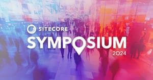 Sitecore Symposium 2024 logo on tradeshow blurry image