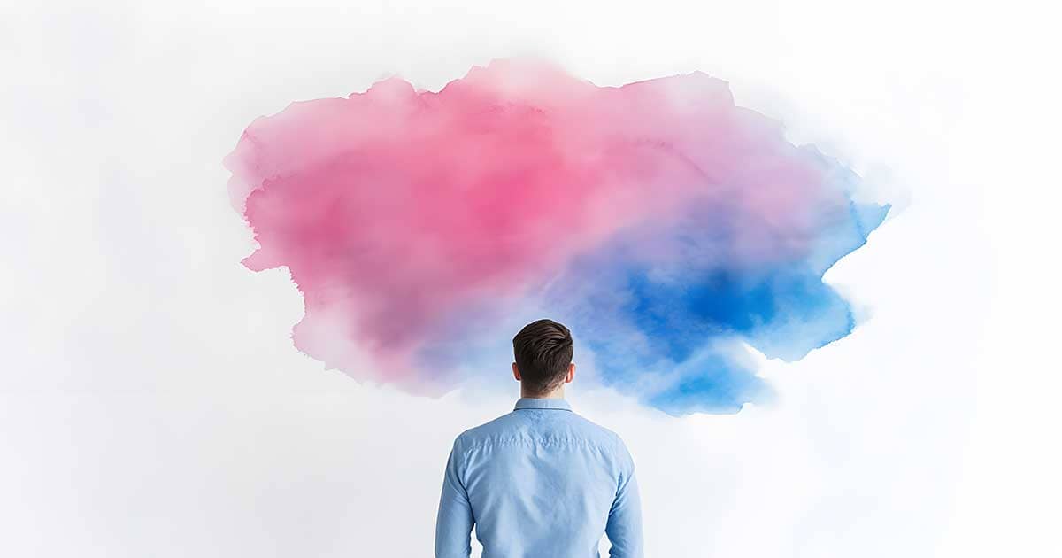 Man in front of a wall looking at a pink/blue painted cloud