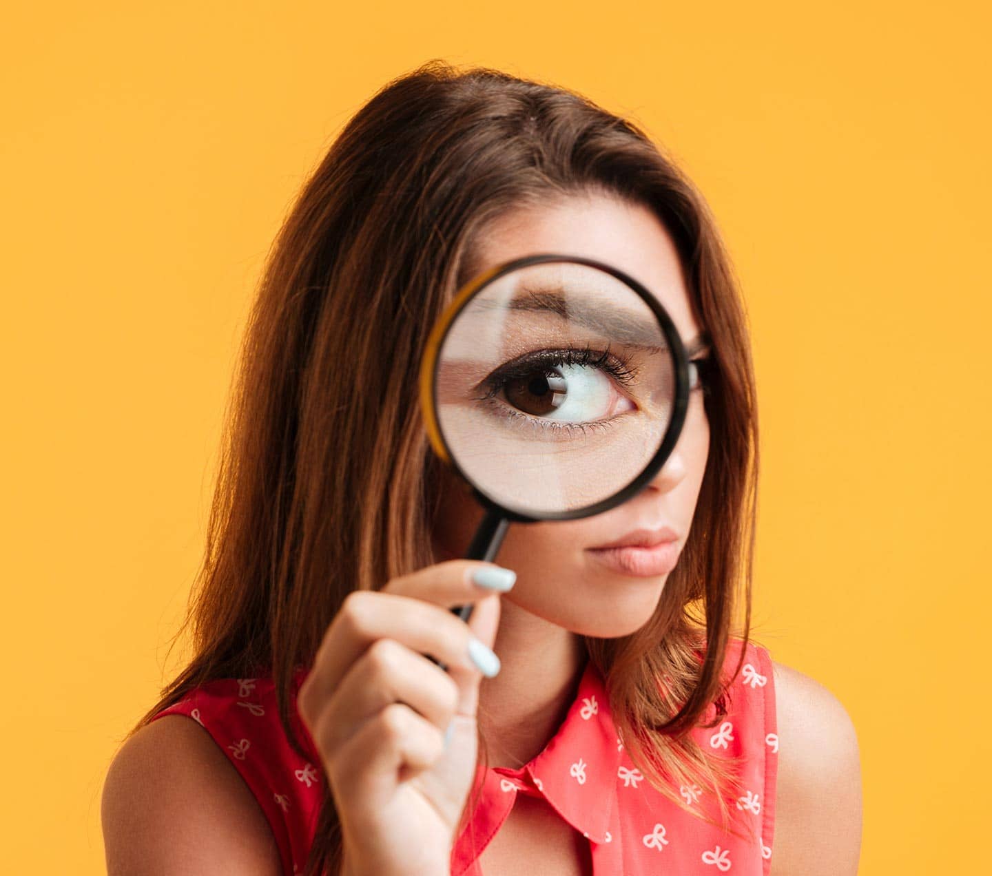 Woman looking though a magnifying glass