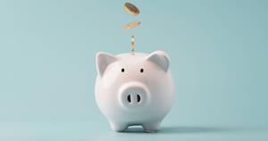 Coins falling to white piggy saving