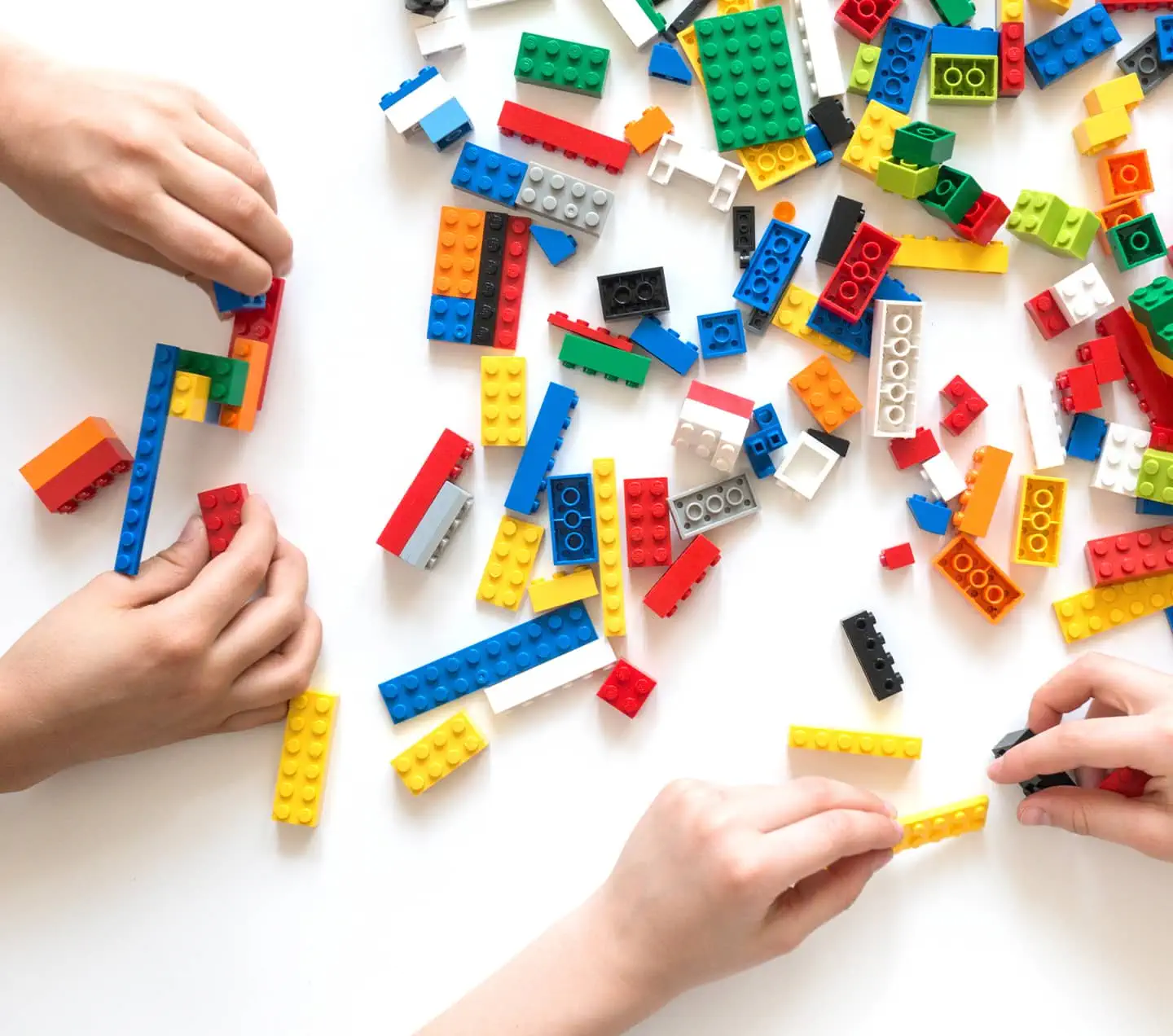 Hands building legos