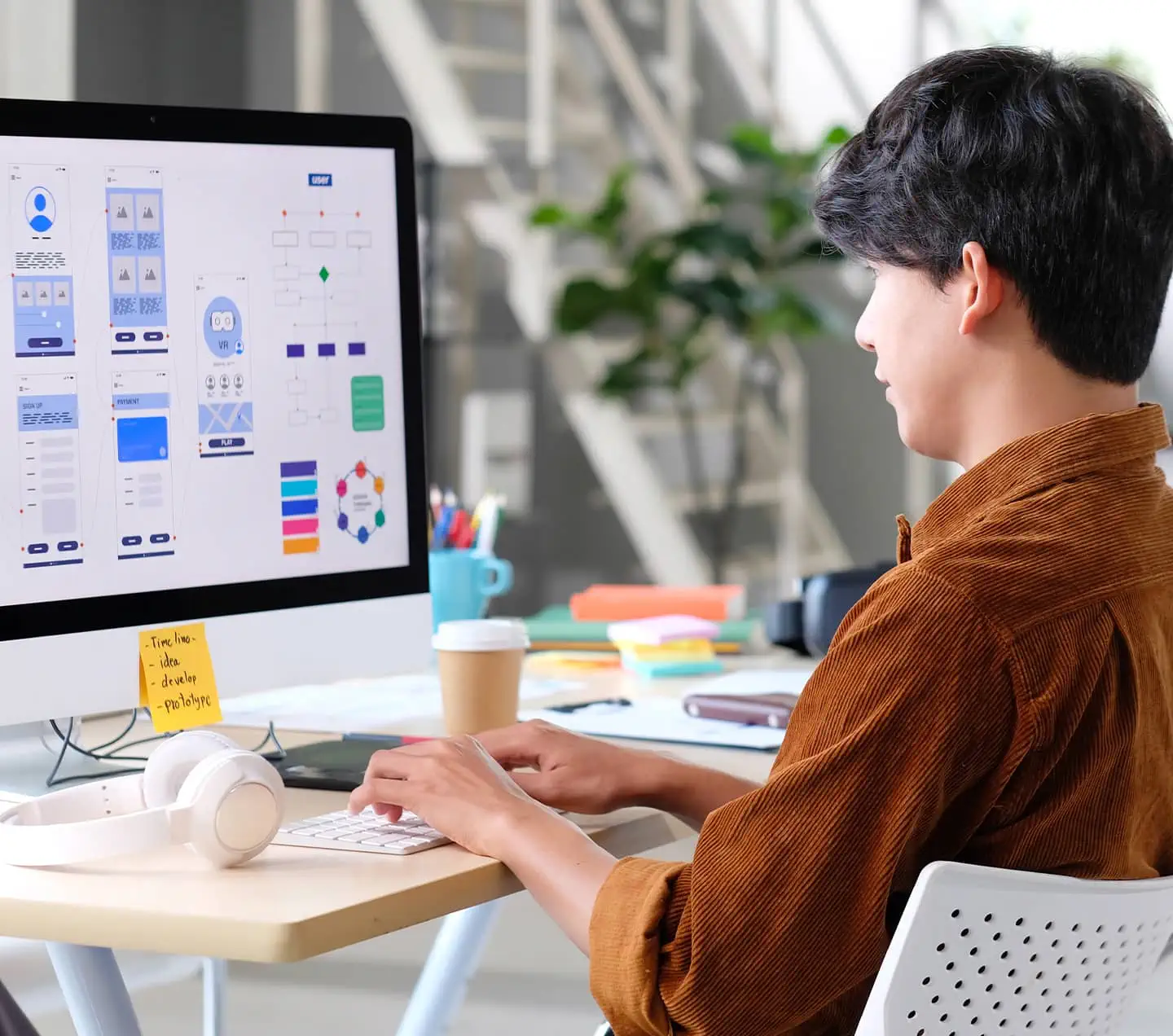 Young asian man UX designer working on Figma