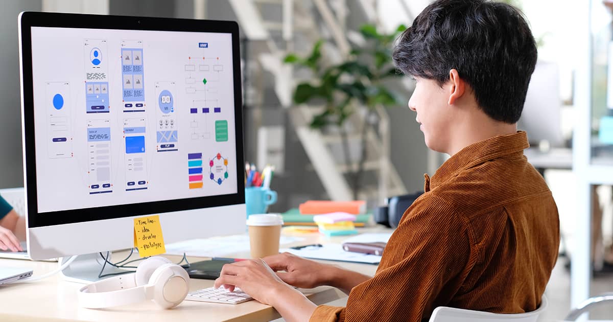 Young asian man UX designer working on Figma