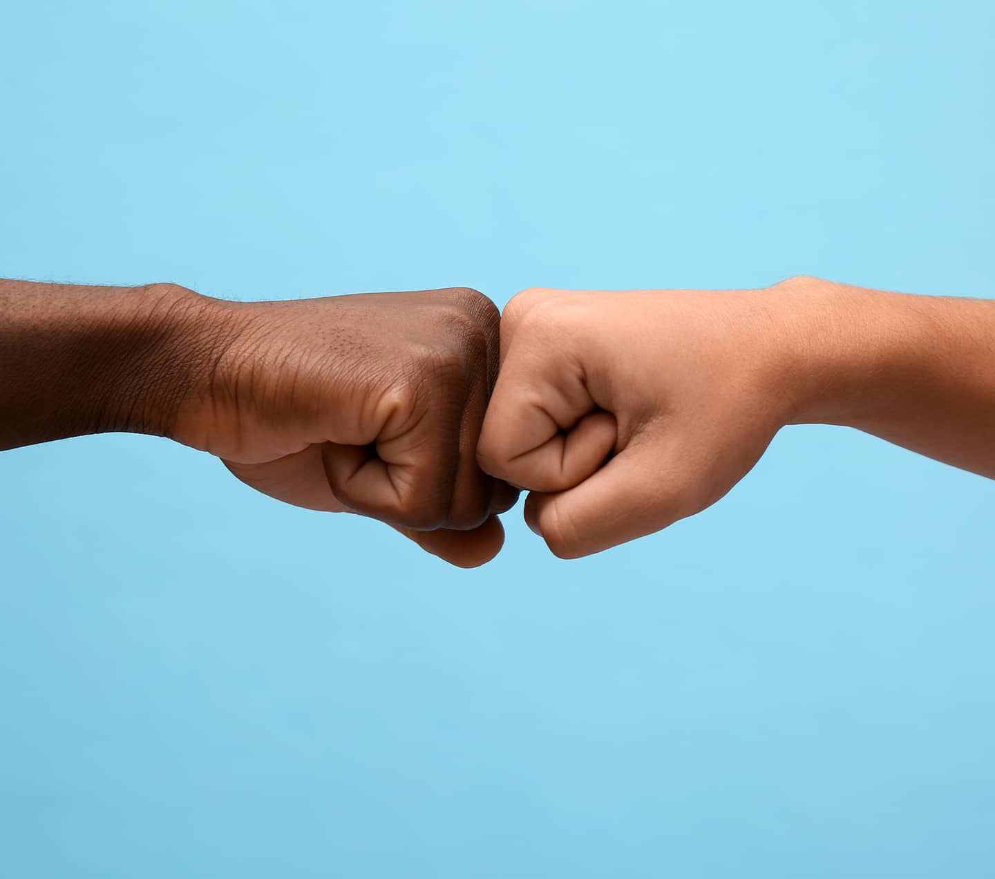 Men fist bumping